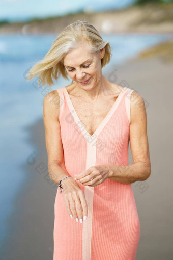 成熟的女人海岸海滩上了年纪的女享受退休海边撤退