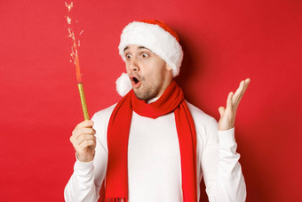 概念圣诞节冬天假期庆祝活动特写镜头惊讶英俊的男人。圣诞老人他围巾炯炯有神的眼睛兴奋站红色的背景