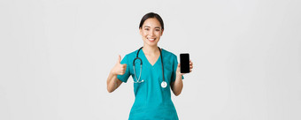 科维德医疗保健工人在线医学概念肖像年轻的亚洲女医生医生实习医生<strong>风云</strong>显示竖起大拇指智能手机屏幕促进应用程序白色<strong>背景</strong>