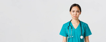 医疗保健工人防止病毒检疫运动概念特写镜头持怀疑态度不情愿的女亚洲医生医疗工人实习医生风云不高兴白色背景