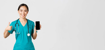 科维德医疗保健工人在线医学概念肖像年轻的亚洲女医生医生实习医生风云显示竖起大拇指智能手机屏幕促进应用程序白色背景