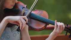 年轻的女孩戏剧小提琴城市公园