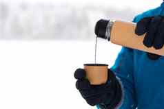 女手倒热茶咖啡杯子热水瓶冬天森林气候变暖喝冷天气