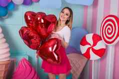 时尚肖像年轻的女人粉红色的衣服空气气球糖果色彩斑斓的背景