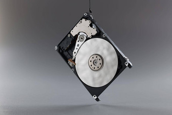 电脑硬磁盘开车钩黑色的硬件磁盘内存存储油缸灰色背景