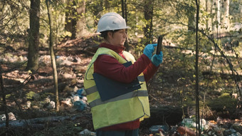 女人<strong>环保</strong>人士工作服头盔记录进攻森林污染