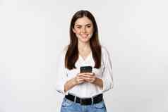 年轻的女人智能手机微笑相机移动电话应用程序细胞技术在线购物概念白色背景
