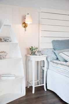 明亮的舒适的卧室室内设计斯堪的那维亚风格花床边表格枕头床上装饰房间室内燃烧小灯表格