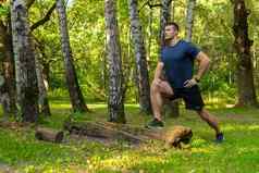 年轻的持久的运动运动员伸展运动森林在户外森林橡木树运行跑步者森林娱乐运动树夏天能源交叉跑步者延伸