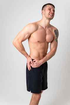 疼痛臀部男人。白色背景强大的疼痛脊柱背景压力持有张力红色的病较低的遭受有吸引力的