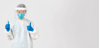 科维德冠状病毒疾病医疗保健工人概念自信亚洲女医生科技实验室员工个人保护设备显示翘拇指持有试管疫苗