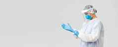 科维德防止病毒健康医疗保健工人检疫概念年轻的医生个人保护设备护士把橡胶手套工作冠状病毒生病的病人