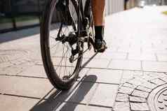 男人。强大的腿骑体育运动自行车城市街