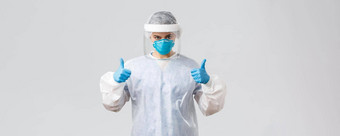 科维德防止病毒健康医疗保健工人检疫概念确定自信医生护士个人保护设备呼吸器手套显示竖起大拇指战斗电晕