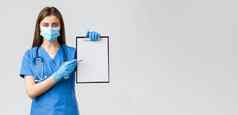 科维德防止病毒健康医疗保健工人检疫概念严肃的表情女护士医生蓝色的实习医生风云开药物治疗指出纸剪贴板