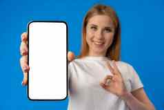 年轻的女人点手指孤立的智能手机屏幕蓝色的颜色背景