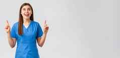 医疗保健工人防止病毒科维德测试筛选医学概念快乐的微笑漂亮的女医生护士蓝色的实习医生风云指出手指欢乐