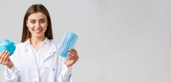 科维德防止病毒医疗保健工人概念微笑有吸引力的女医生白色实习医生风云显示变体个人保护设备显示呼吸器医疗面具