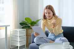 女人享受内容社会媒体应用程序数字平板电脑坐着沙发首页