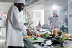 食物行业工人专业厨房切新鲜的绿色烹饪美食菜晚餐服务