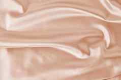 光粉红色的丝绸背景折叠摘要纹理波及缎表面