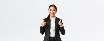 自信微笑亚洲女售货员黑色的西装显示竖起大拇指保证质量产品提供服务销售经理出售客户端白色背景