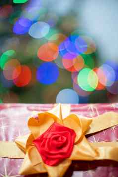 礼物系金丝带红色的弓礼物盒子弓礼物圣诞节闪亮的圣诞节树灯背景