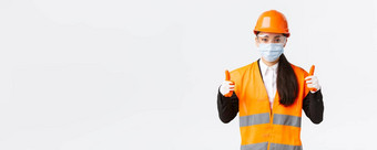 科维德安全协议<strong>企业建设</strong>防止病毒概念自信女亚洲工业工人工程师脸面具头盔显示竖起大拇指好