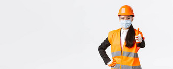 科维德安全协议企业建设防止病毒概念自信亚洲女工程师架构师脸面具头盔显示翘拇指保证质量建筑