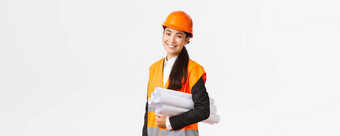 微笑成功的亚洲女架构师建设工程师安全头盔携带蓝图微笑快乐相机介绍建筑项目站白色背景
