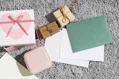 问候卡情人节一天信封包装盒子陶瓷粉红色的心灰色毛茸茸的地毯背景复制空间的地方文本