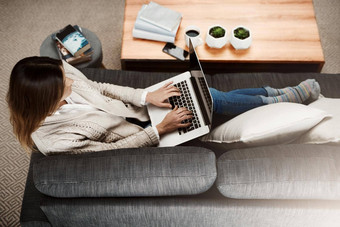 工作首页感觉工作拍摄有吸引力的年轻的女人坐着沙发工作首页移动PC