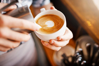 使图片裁剪拍摄认不出来咖啡师倒泡沫牛奶杯热咖啡把图片