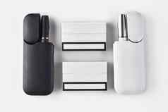 黑色的白色电子香烟开放电池包孤立的白色高新技术加热烟草系统关闭平躺
