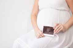怀孕了女人照片超声波怀孕享受怀孕快乐时间妈妈。可爱的大肚子