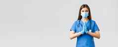 科维德防止病毒医疗保健概念祈祷医疗工人女护士医生蓝色的实习医生风云医疗面具战斗冠状病毒新闻手充满希望的恳求