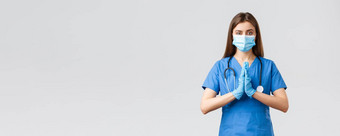 科维德防止病毒医疗保健概念祈祷医疗工人女护士医生蓝色的实习医生风云医疗面具战斗冠状病毒新闻手充满希望的恳求