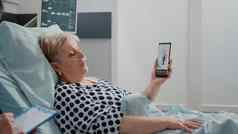 岁的病人持有智能手机视频调用医生