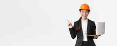 兴奋快乐亚洲女工程师工业女人安全头盔业务西装显示演讲指出手指图图表持有移动PC电脑微笑惊讶