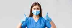 科维德防止病毒健康医疗保健工人检疫概念特写镜头支持女护士医生蓝色的实习医生风云医疗面具手套竖起大拇指批准