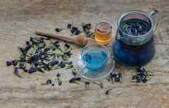蝴蝶(2008年)茶Clitoria有机蓝色的anchan茶壶玻璃杯服务蜂蜜木背景