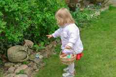 女孩狩猎复活节蛋春天花园
