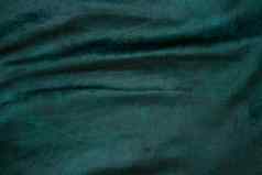 丝绒织物纹理背景绿色天鹅绒丝绒布背景发光的光黑暗阴影背景剧院时尚设计主题