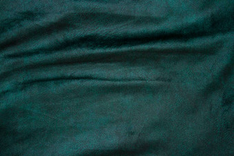 丝绒织物纹理背景绿色天鹅绒丝绒布背景发光的光黑暗阴影背景剧院时尚设计主题