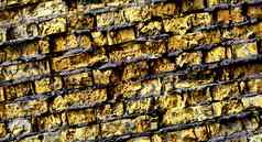 大完整的背景详细的黑暗黄色的砖墙