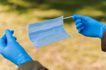 流行病学方法预防保护“非典”浸医疗面具手蓝色的无菌手套