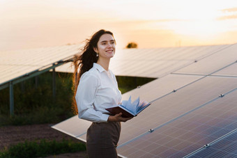 女孩太阳能面板站行地面日落太阳能细胞权力植物业务