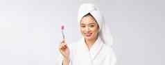 关闭微笑女人刷牙齿伟大的健康牙科护理概念孤立的白色背景亚洲