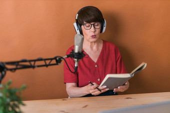 中年女广播主持人会说话的麦克风阅读新闻广播广播在线概念