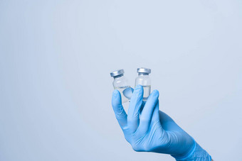 特写镜头科维德疫苗接种剂量冠状病毒疫苗女人蓝色的医疗手套持有药物治疗